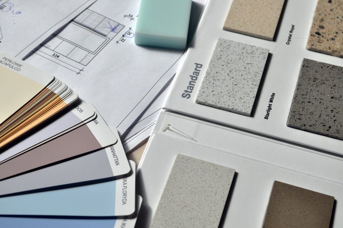Picking your finishes is an important (and fun!) part of custom home design. Here you can see some tiles and paint strips that a family would choose from.